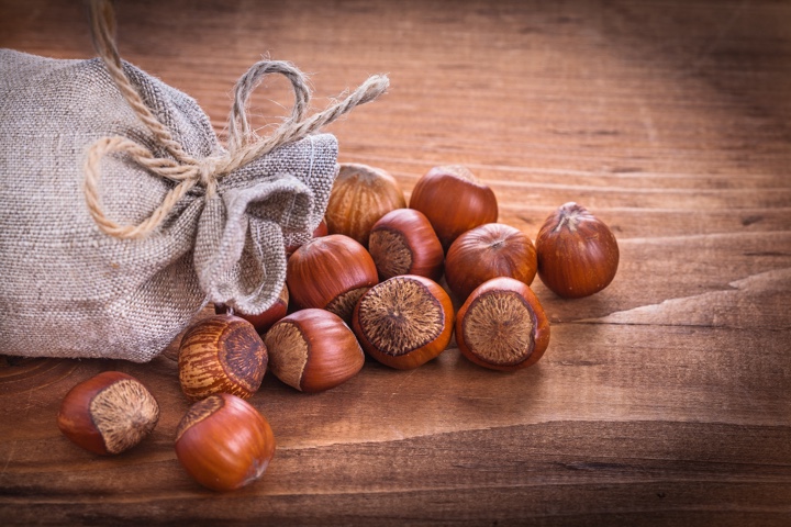 hazelnuts sack on vintage wooden board food and drink concept